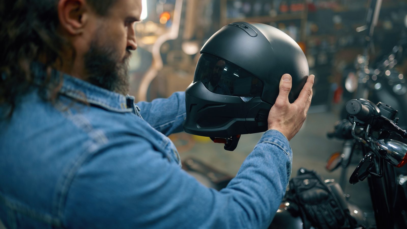 Pilote comparant des casques de moto sur les étagères d'une boutique spécialisée